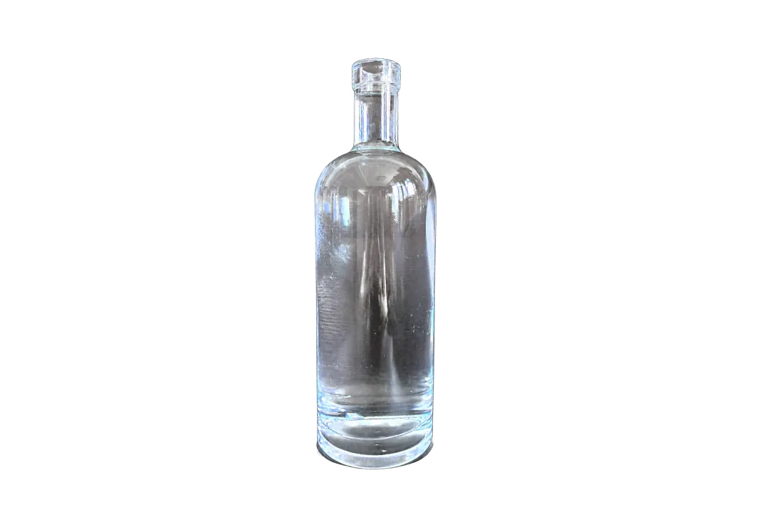Clear cylindrical glass bottle with a clear stopper on a dark textured background